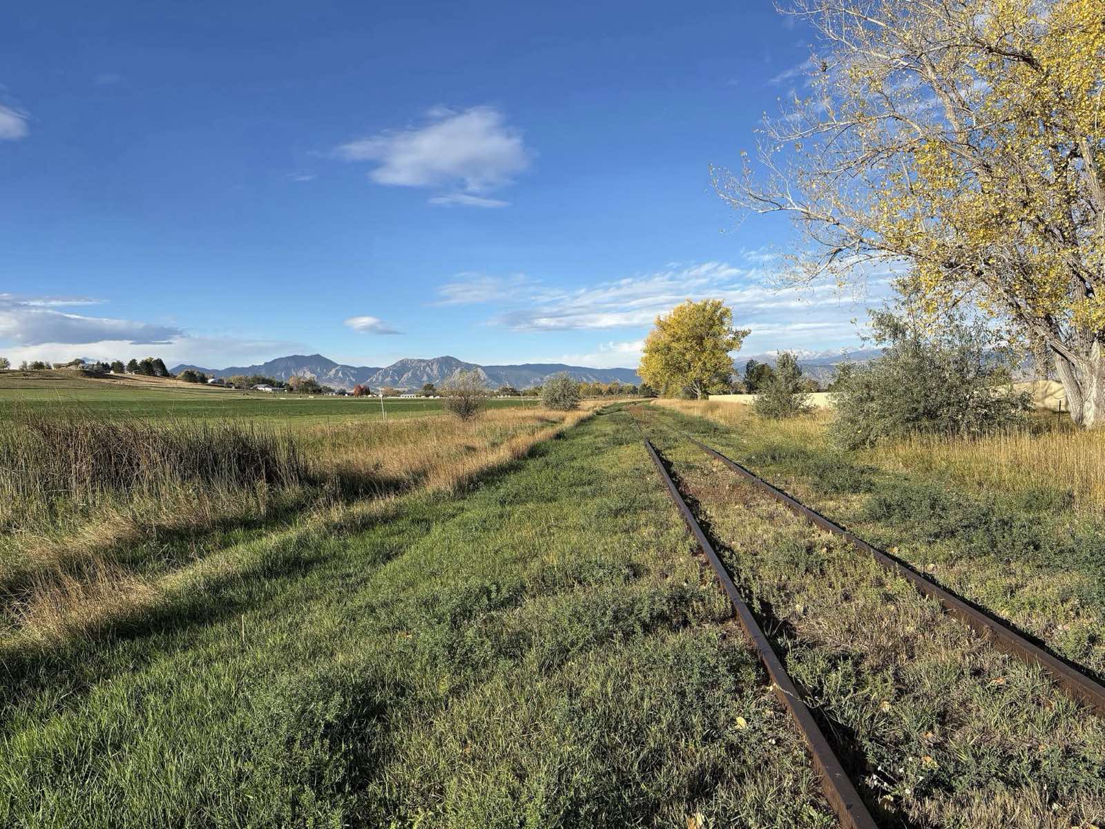 Old rail line running toward the Flatirons in Boulder County